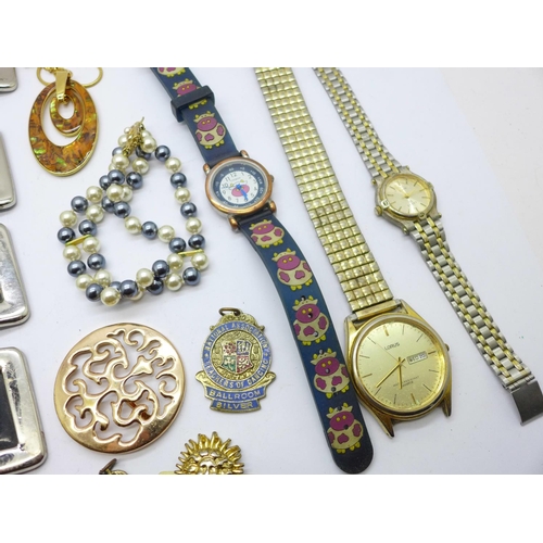 883 - A silver bracelet with enamel charms, costume jewellery and wristwatches