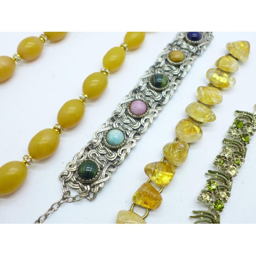 885 - A citrine set bracelet, a Celtic bracelet, a paste set necklace and a Bakelite necklace