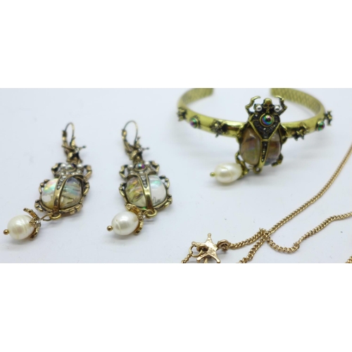 886 - A modern scarab beetle jewellery set, a bangle, pendant and chain and a pair of earrings, set with a... 