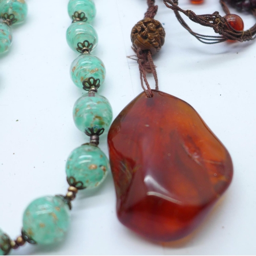 890 - Four necklaces; jet, garnet and amber, one a/f and a malachite bracelet