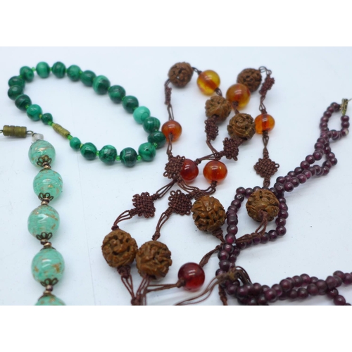 890 - Four necklaces; jet, garnet and amber, one a/f and a malachite bracelet