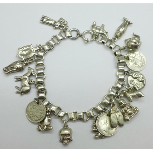 932 - A white metal charm bracelet, 50g