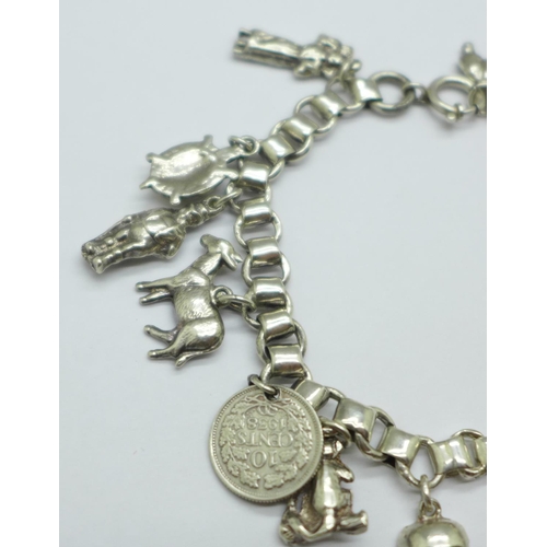 932 - A white metal charm bracelet, 50g