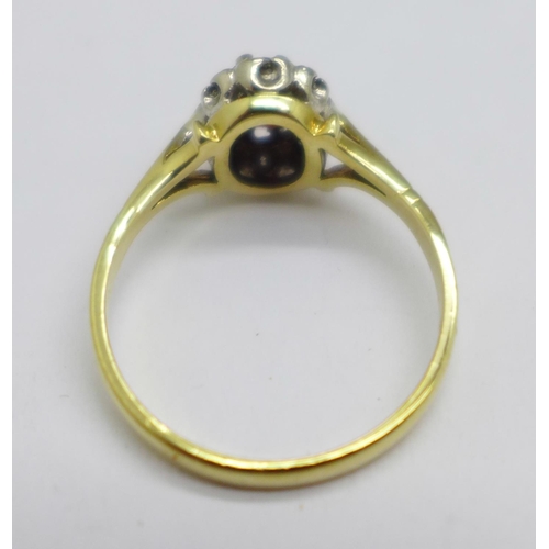 946 - An 18ct gold, garnet and diamond cluster ring, 3.4g, O