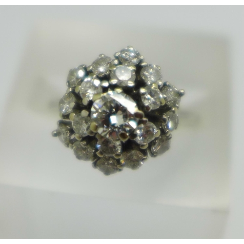 959 - A white metal, diamond set Art Deco ring, with nineteen diamonds in total, the centre stone approxim... 