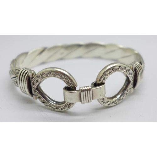 973 - A large silver and diamond encrusted bangle, approximately 2carat diamond weight, 88g