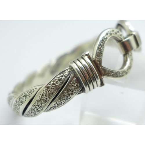 973 - A large silver and diamond encrusted bangle, approximately 2carat diamond weight, 88g