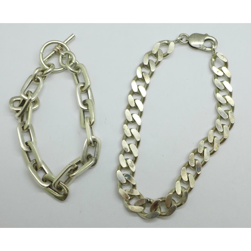 974 - A silver curb link bracelet and a white metal bracelet, 56g