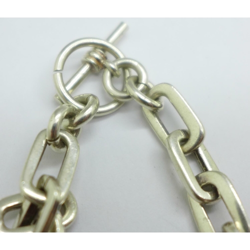 974 - A silver curb link bracelet and a white metal bracelet, 56g