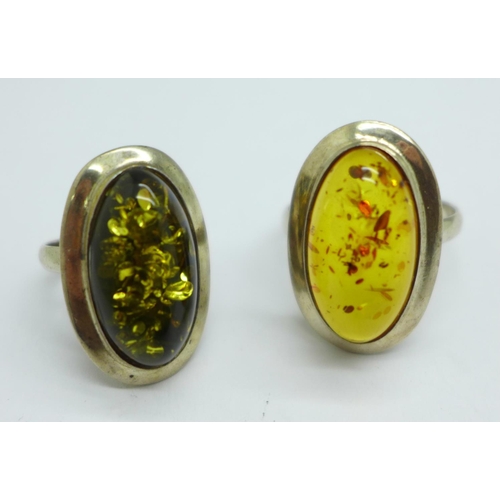 976 - A silver and green amber ring and a silver and amber ring