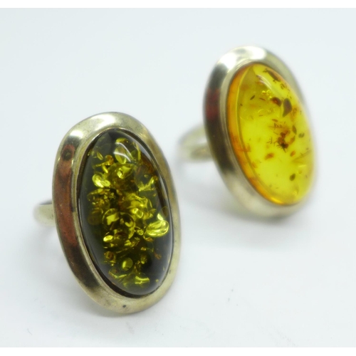 976 - A silver and green amber ring and a silver and amber ring