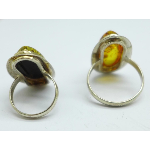 976 - A silver and green amber ring and a silver and amber ring