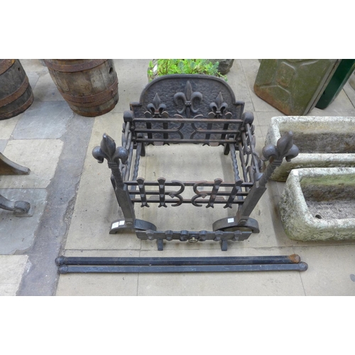 327 - A pair of wrought and cast iron andirons and fire grate