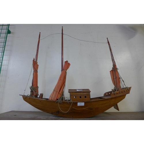 389 - A wooden model of an oriental junk