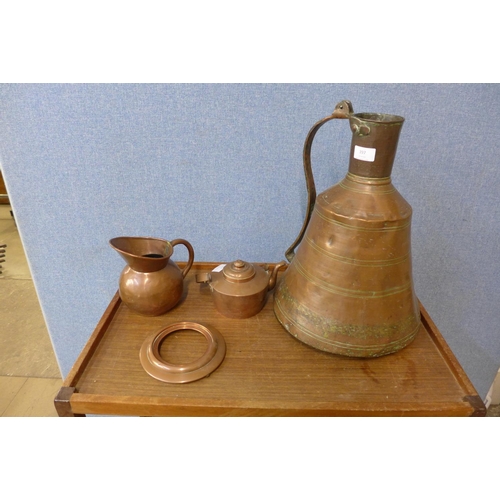 398 - Two copper jugs and a spirit kettle