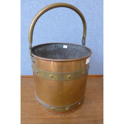 414 - An Arts and Crafts brass and copper coal bucket