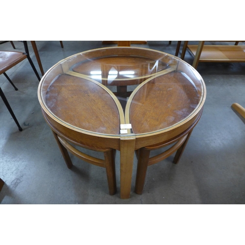 124 - A Nathan teak and glass topped circular nest of tables