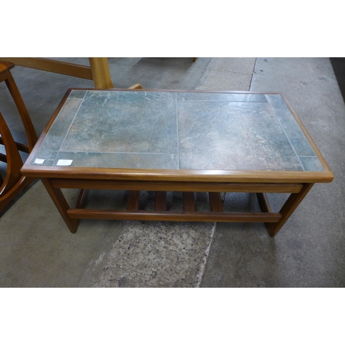 127 - A teak and tiled top coffee table