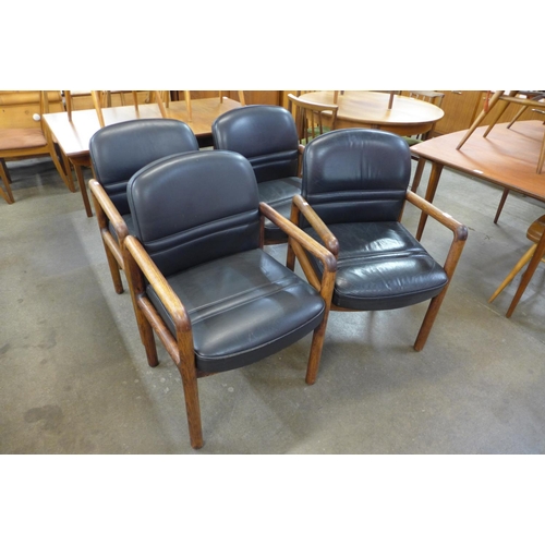 131 - A set of four Gordon Russell oak and leather armchairs