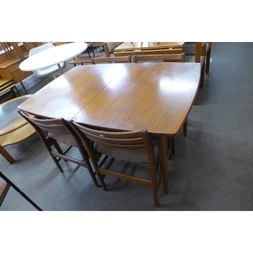 144 - A teak extending dining table and four chairs