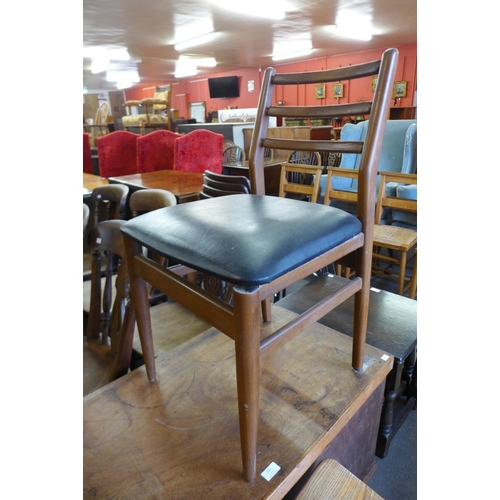 169 - A Scandarf teak extending dining table and four chairs