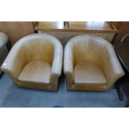 187 - A pair of caramel leather tub chairs