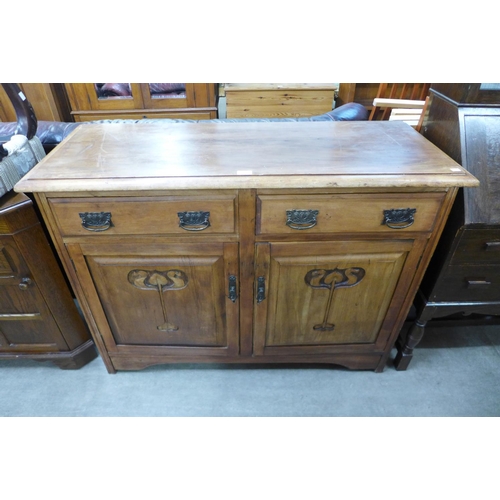 227 - An Arts and Crafts carved walnut sideboard