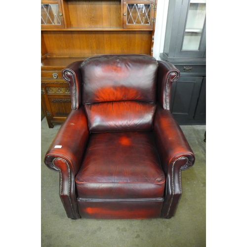 239 - A Thomas Lloyd red leather armchair