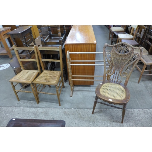 262 - A Victorian Heywood Wakefield wicker bedroom chair, another pair of chairs and a towel rail