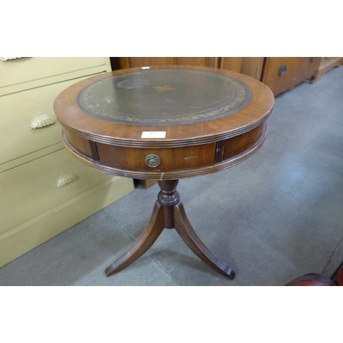 263 - A mahogany and green leather topped drum shaped occasional table