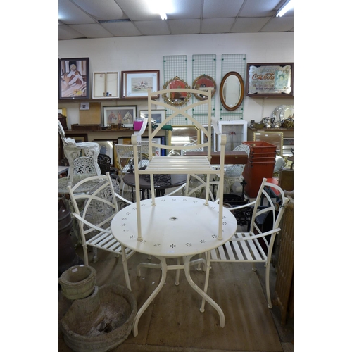 305 - A circular metal garden table and four chairs