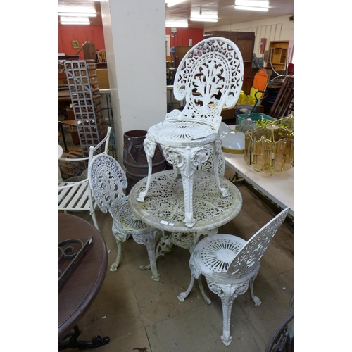 331 - A cast alloy garden table and four chairs