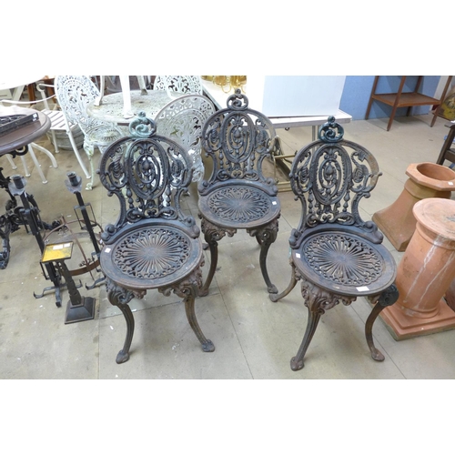 334 - A set of three Victorian style cast iron garden chairs