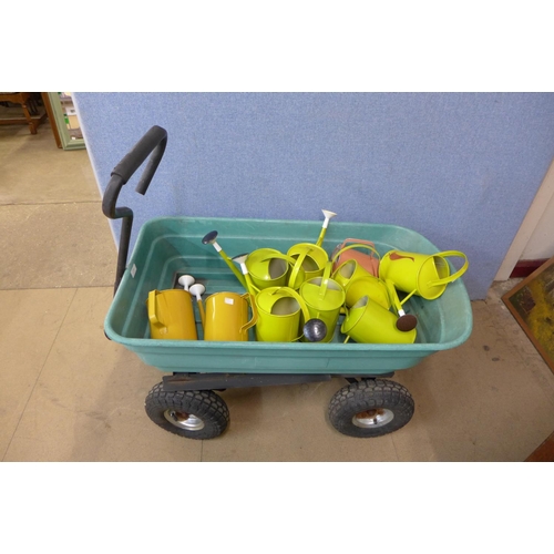 343 - Ten watering cans and a trolley