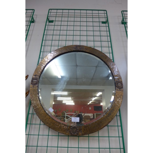 378 - An Arts and Crafts hammered copper framed circular mirror