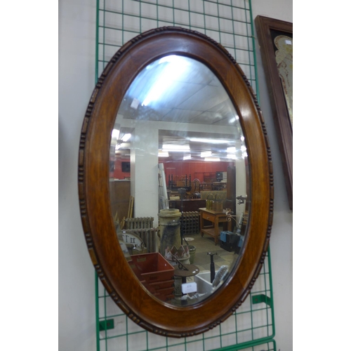 379 - An oak oval framed mirror