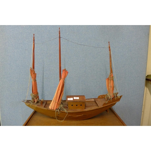 389 - A wooden model of an oriental junk