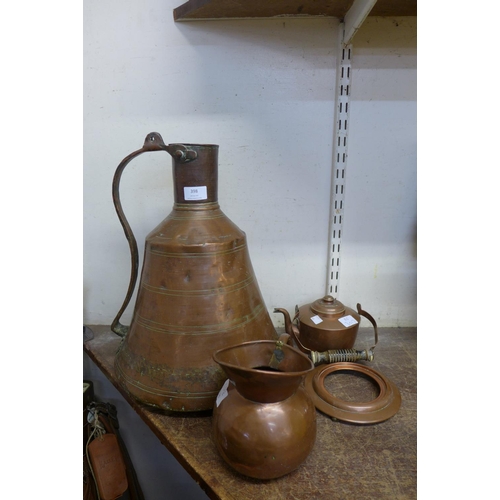 398 - Two copper jugs and a spirit kettle