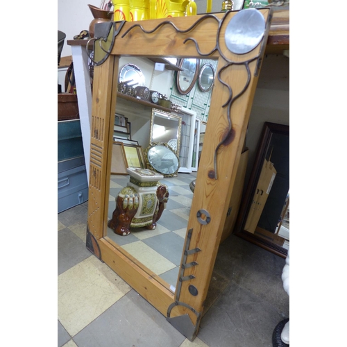 408 - A pine and metalwork framed mirror