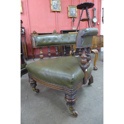 71 - An early Victorian mahogany and green faux leather tub shaped library chair