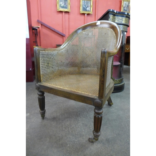 72 - A George IV rosewood bergere library armchair