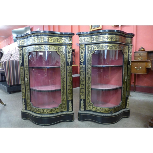 73 - A pair of Boulle style ebonised and brass inlaid serpentine corner cabinets