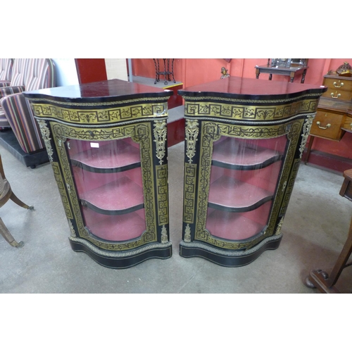 73 - A pair of Boulle style ebonised and brass inlaid serpentine corner cabinets