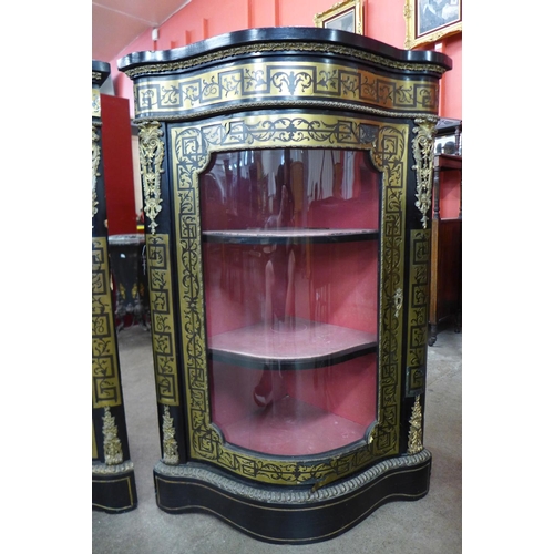 73 - A pair of Boulle style ebonised and brass inlaid serpentine corner cabinets