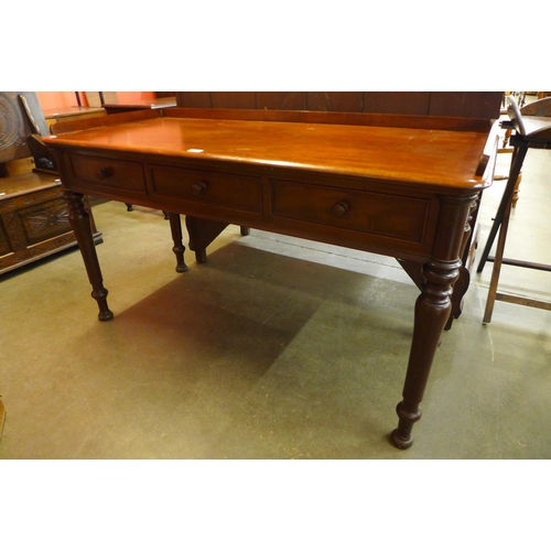 87 - A Victorian mahogany three drawer writing table