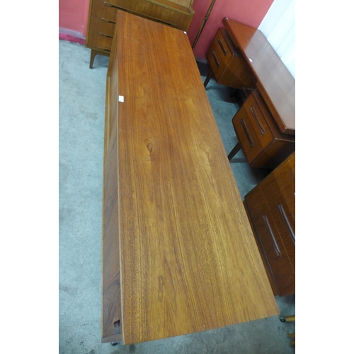 89 - A teak and chrome ended sideboard