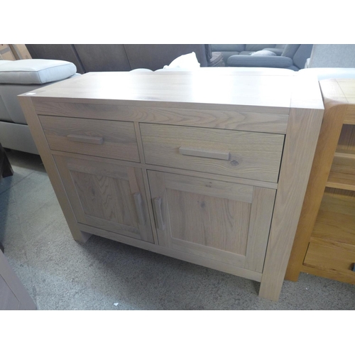 1570 - A washed oak two door sideboard  * this lot is subject to VAT