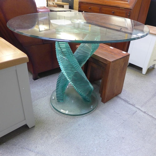 1869 - A glass circular dining table