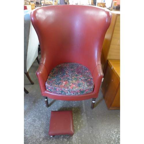 222 - A George III style mahogany and faux red leather armchair and footstool