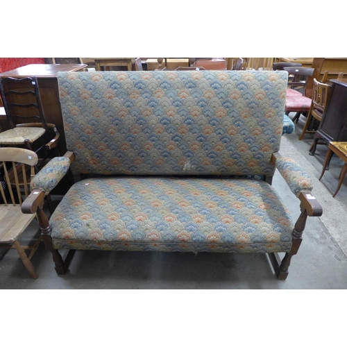 312 - A 1930's oak and upholstered settle